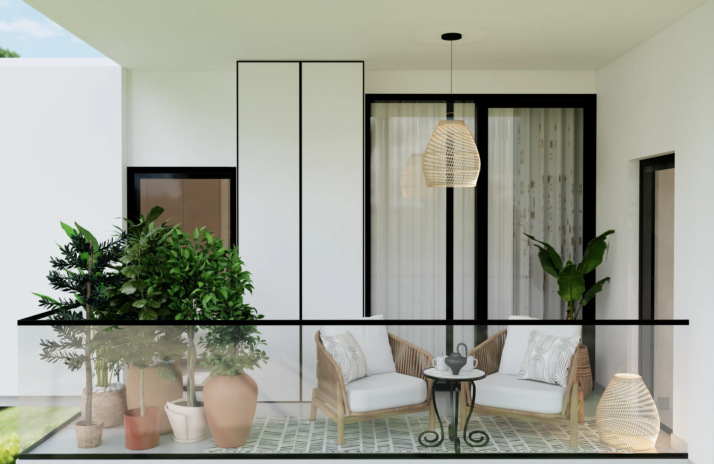 The Soft Canvas balcony with rattan armchairs planters and glass railing JVC Dubai
