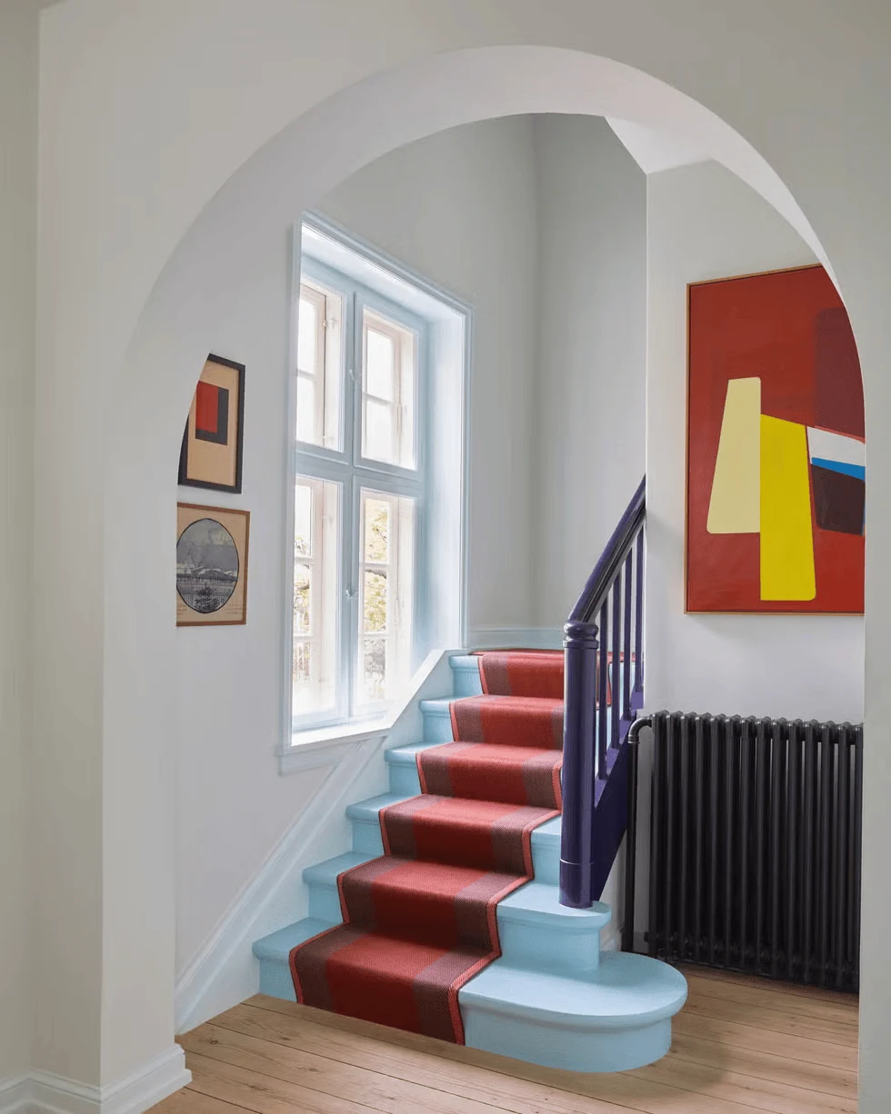 archway accent staircase gallery wall in a structural corner