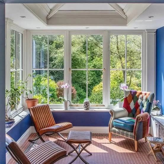 small sunroom ideas with floor to ceiling windows and mid century furniture