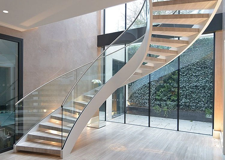 curved glass staircase railing for a soft grand look in a luxury villa