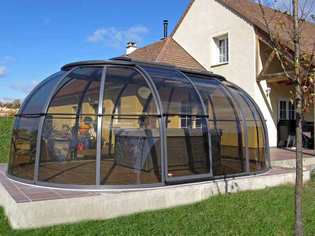 modern sunroom ideas with a curved retractable glass enclosure