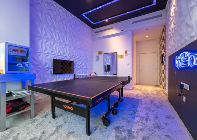 games room with a table tennis table and neon lighting