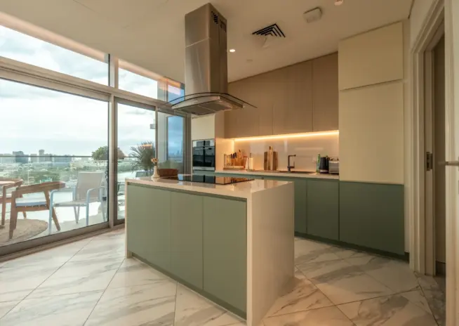 kitchen with sage green cabinets and a large island