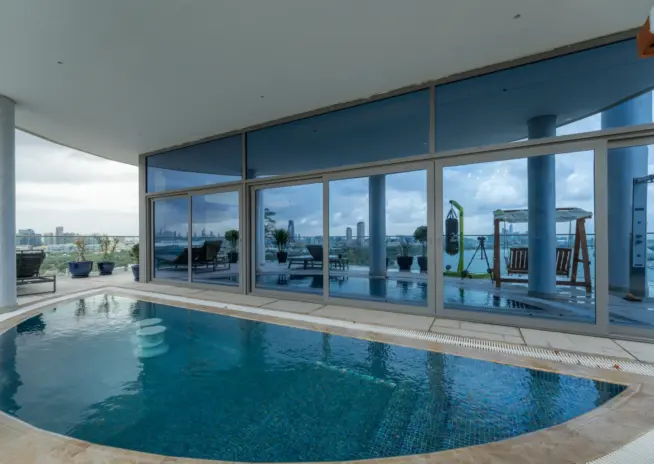 indoor swimming pool beside floor to ceiling windows