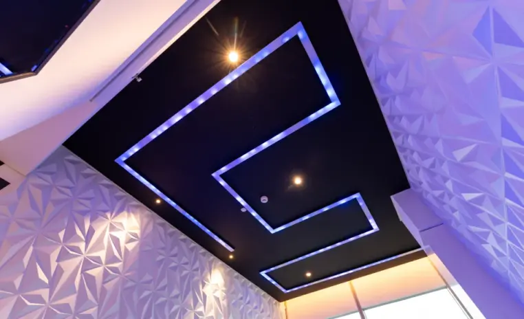 ceiling detail with neon strip lighting and textured panels