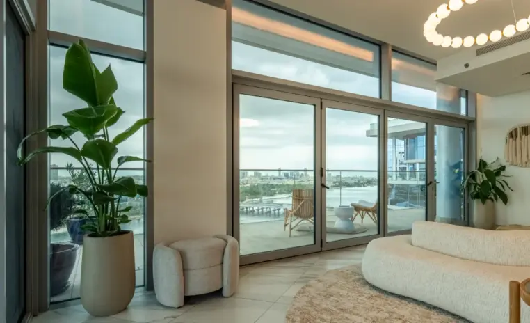 living area with tall windows and indoor plants