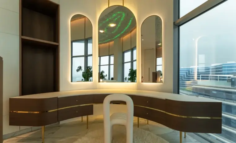 dressing area with arched mirrors and a curved vanity