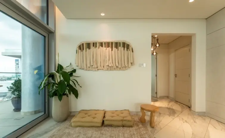 entrance area with a low bench a pendant light and plants