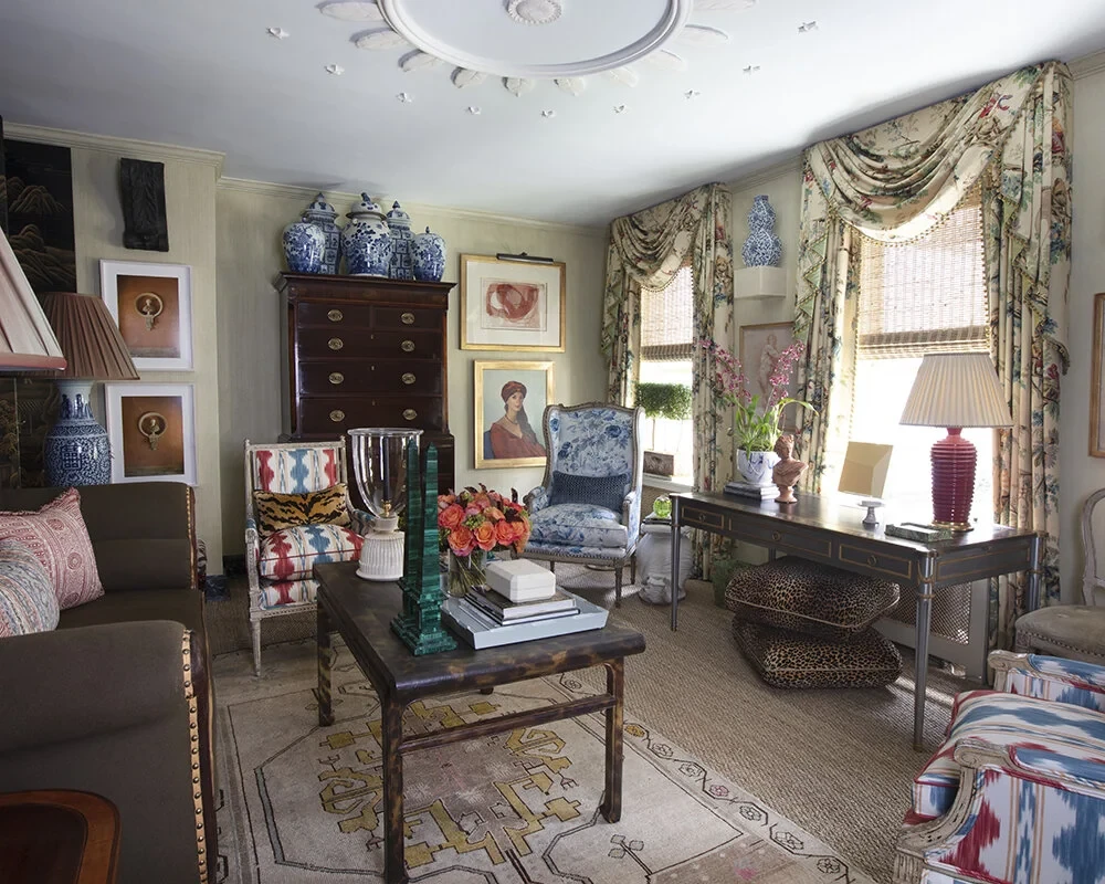 grandmillennial style interior with a tall antique chest of drawers as the hero piece