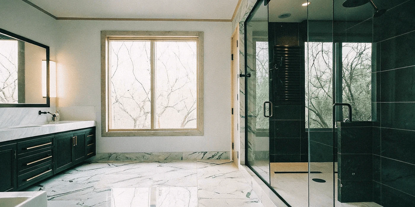 modern bathroom designs using large format porcelain slabs in the shower