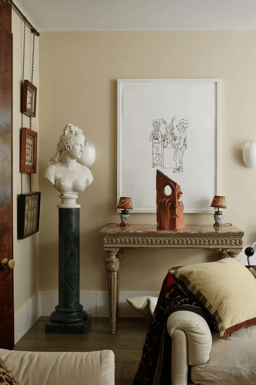 add a small bust sculpture or classical object with restraint light academia decor