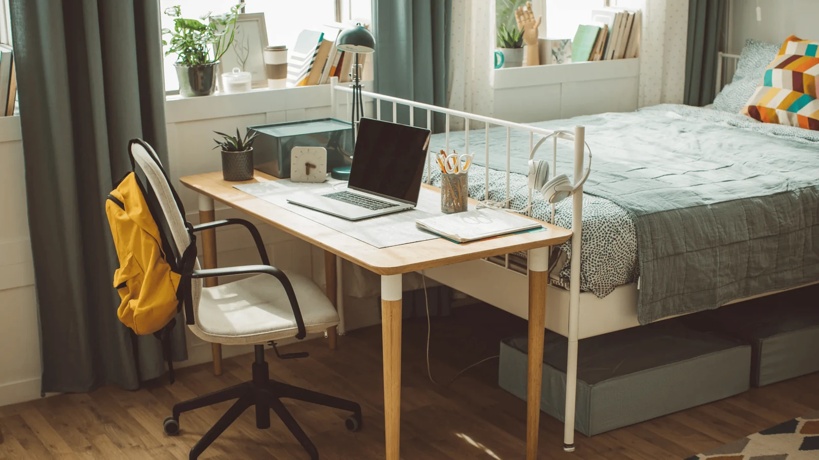 minimalist dorm room with a clean desk and everyday items within reach