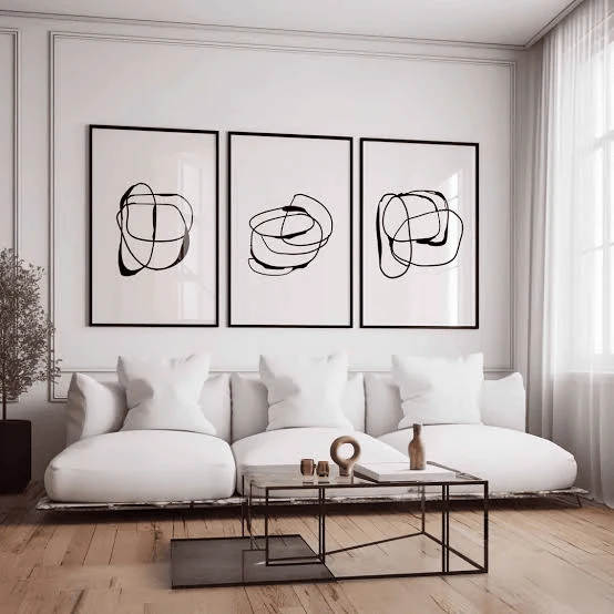 minimalist symmetrical triptych modern gallery wall in an apartment