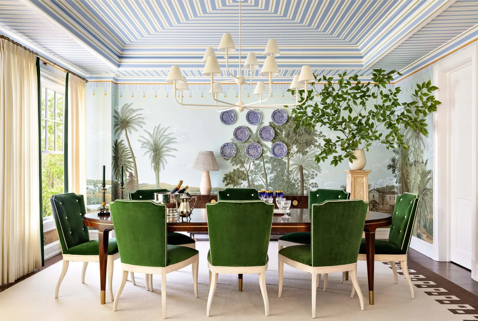 modern grandmillennial style with blue and white wall plates and a sculptural chandelier