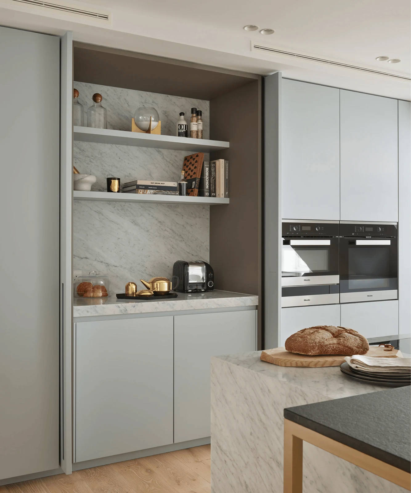 hide a busy breakfast zone behind sage pocket doors