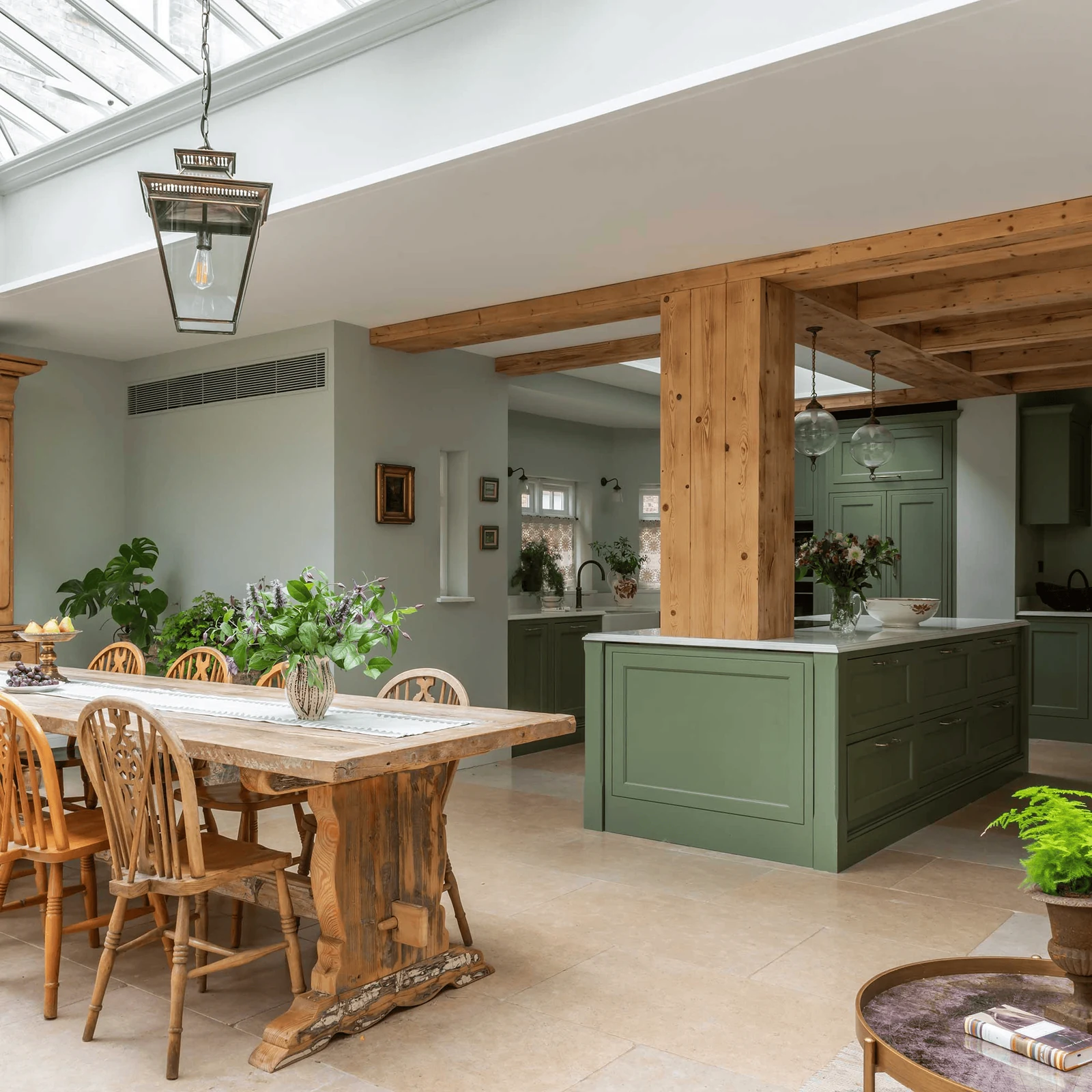 let a timber ceiling beam carry the wood sage green kitchen