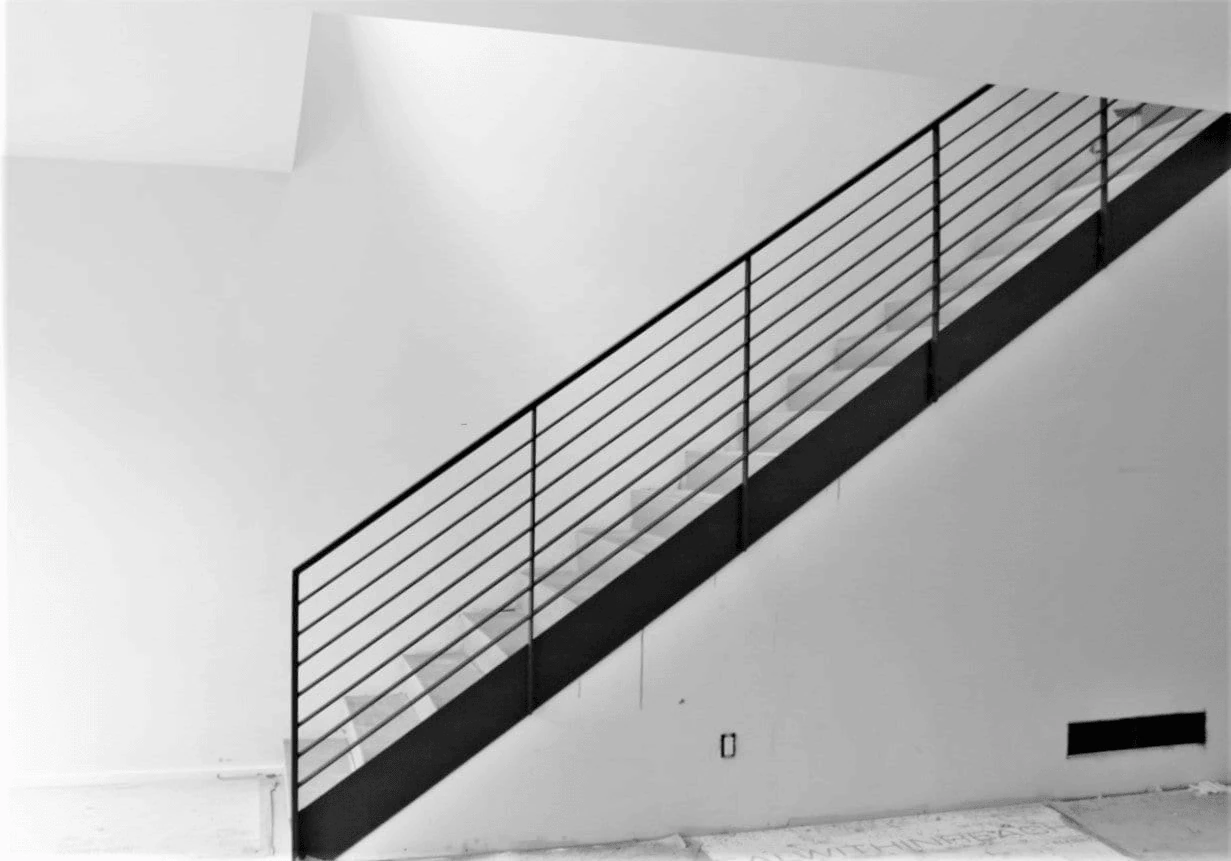 slim horizontal metal stair rails making a staircase look wider