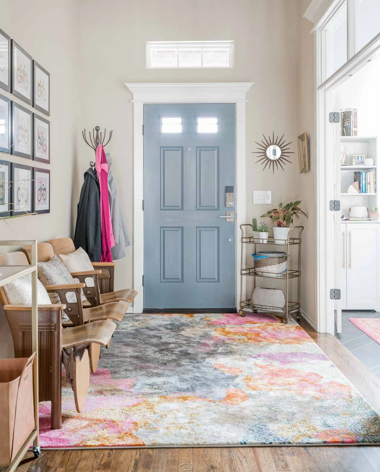 foyer area design defined by a statement rug at the front door