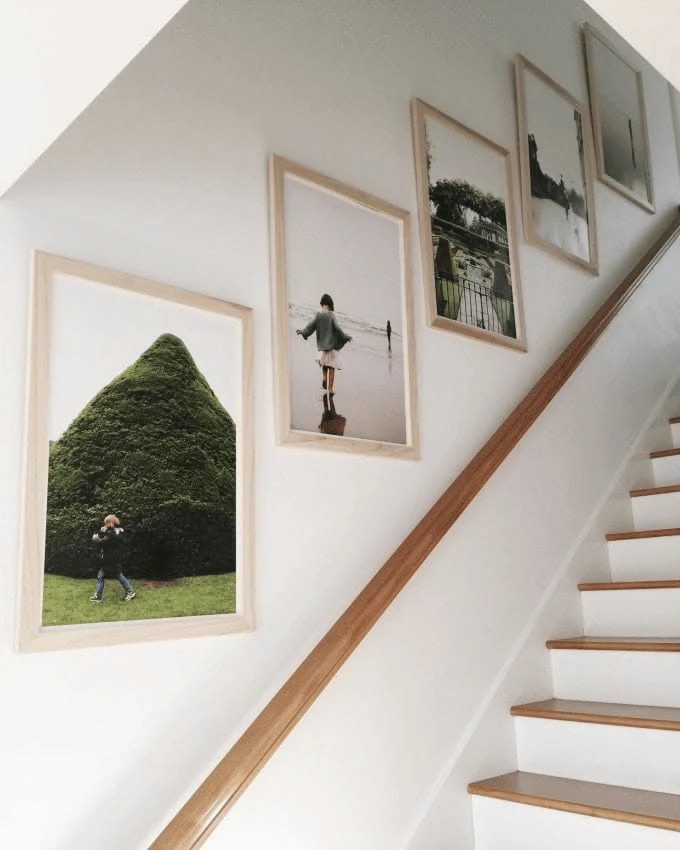 timber incline staircase photo wall with light oak frames