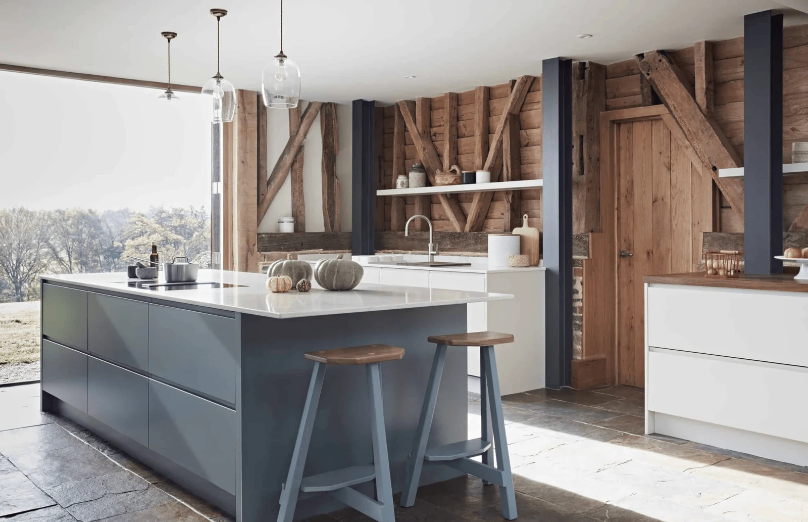 timeless kitchen with stone flooring and wooden accent