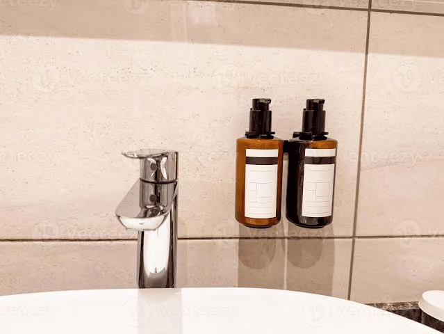 bathroom remodel ideas using a wall mounted soap dispenser to clear the basin