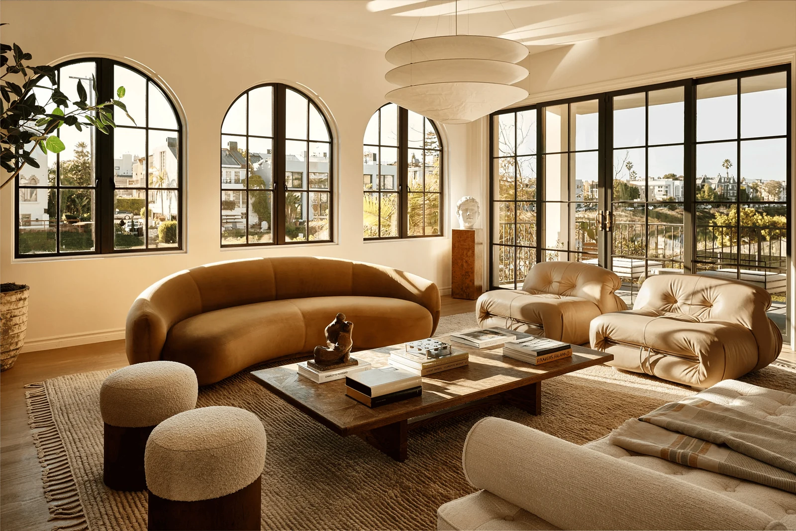 warm minimalism interior design with curved seating and soft neutral tones