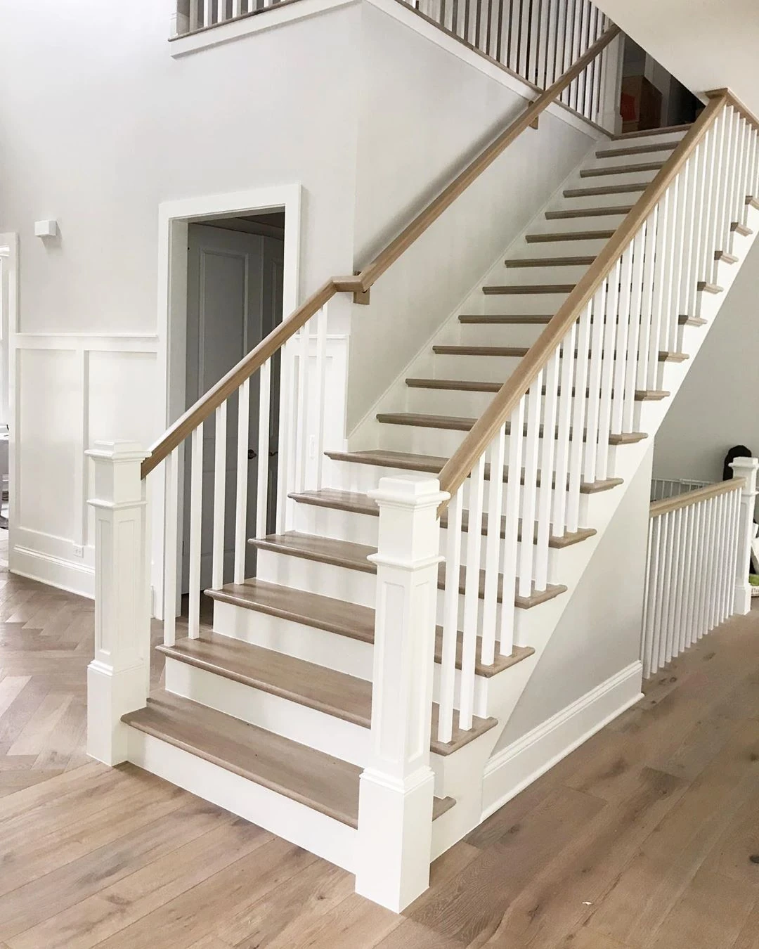 white stair balusters with a timber handrail for a clean classic look