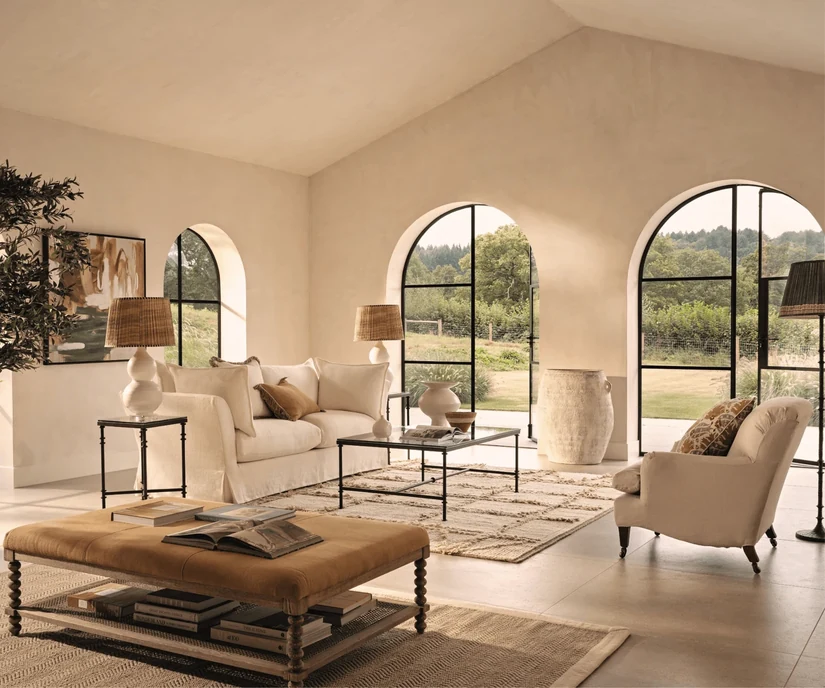 modern mediterranean interior style living room with arched windows and soft neutrals