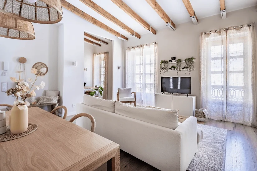 mediterranean interior style townhouse living room with timber beams and linen